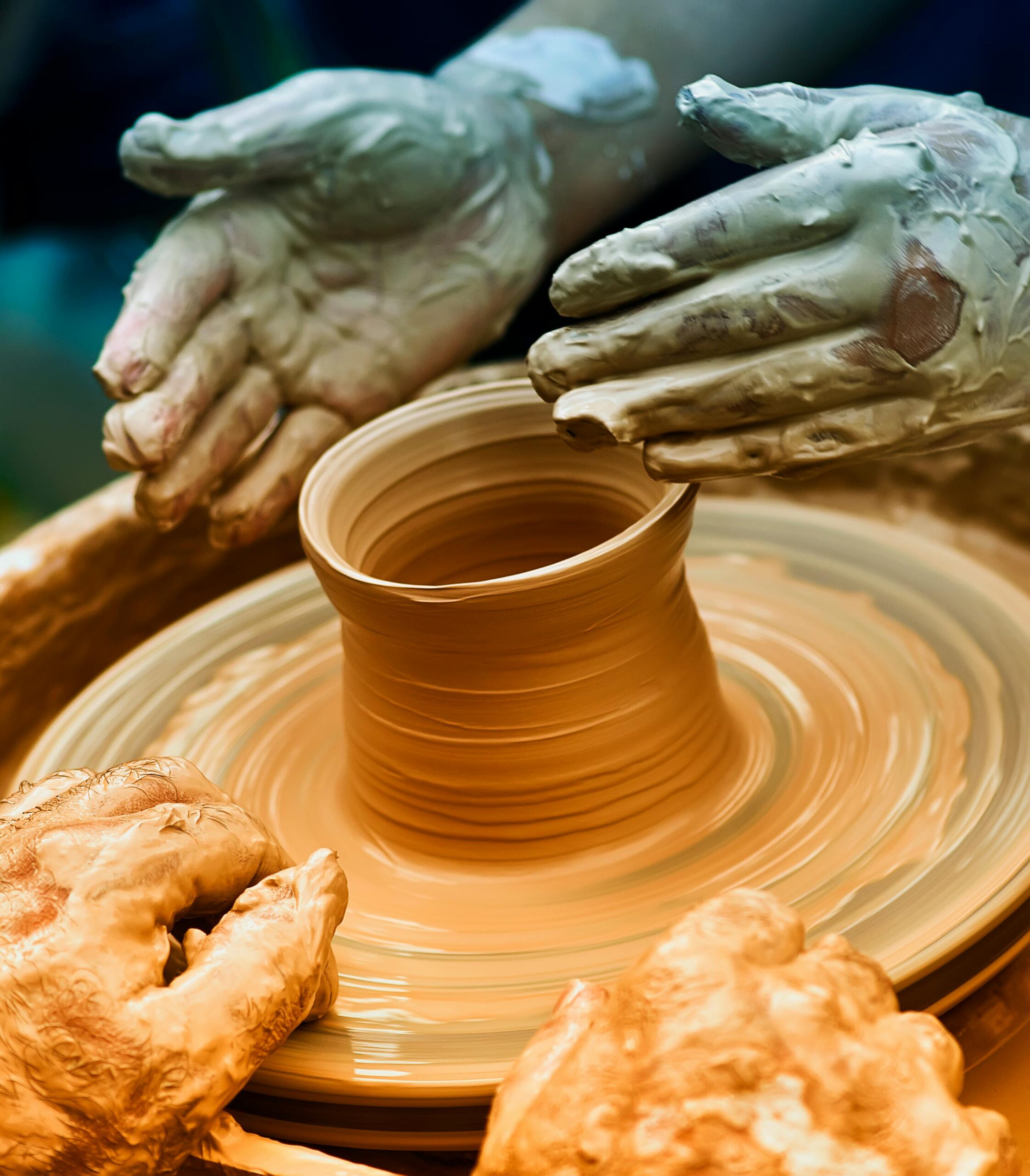 Artisan shaping clay on pottery wheel, showing craftmanship and precision.