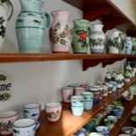 Vibrant handmade pottery displayed in a shop in Pythagoreio, Greece. Perfect for decor lovers.